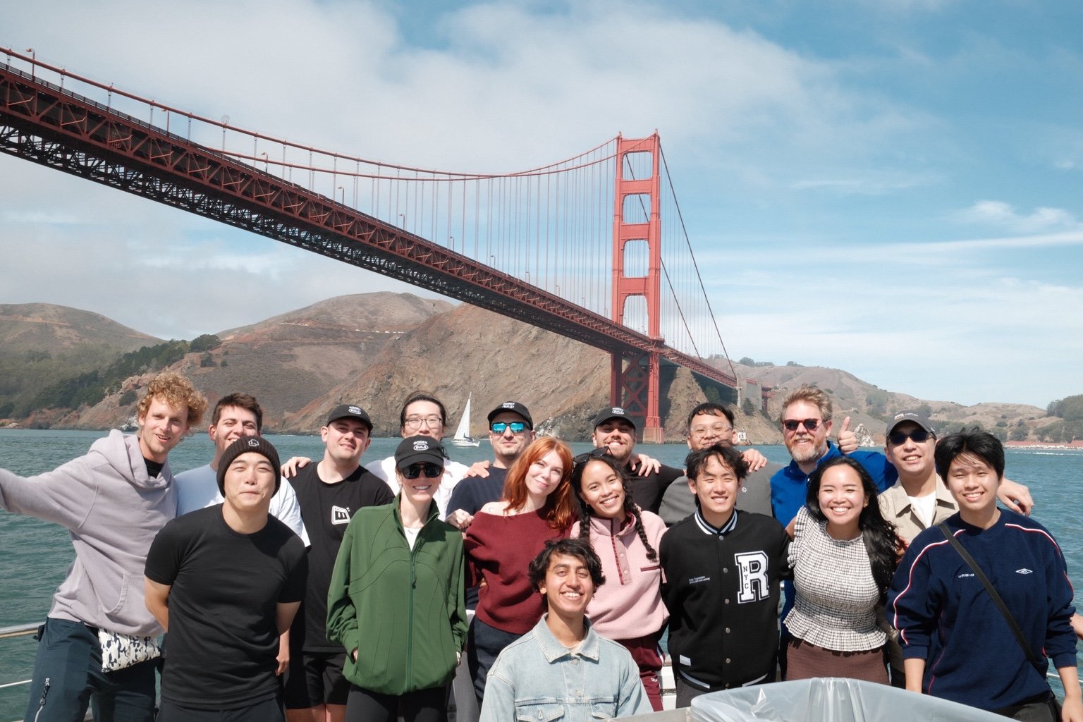 Codex Ambassadors together on a boat in San Francisco Bay with the Golden Gate Bridge behind them