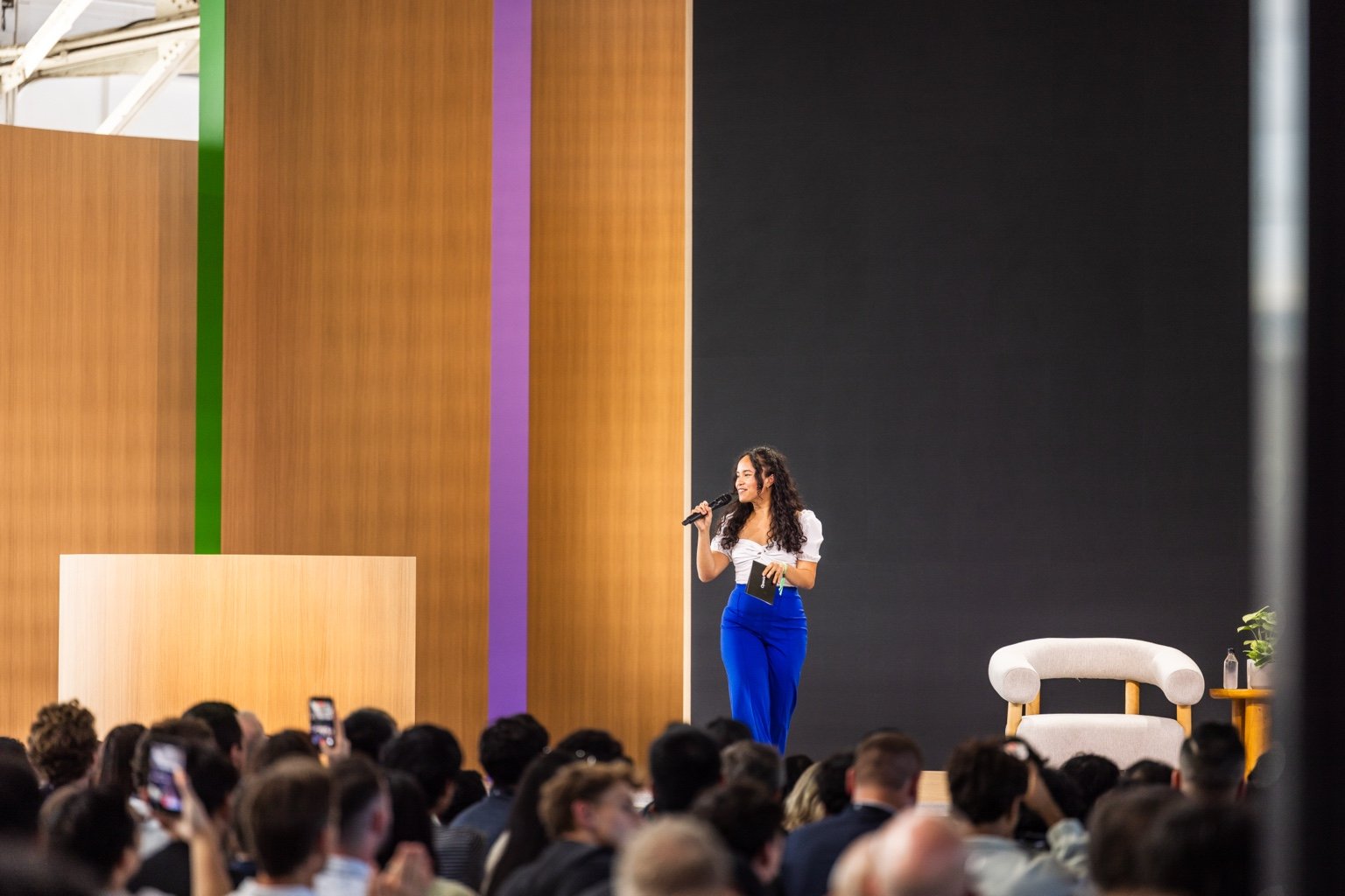 Pauline speaking into a microphone on the OpenAI DevDay stage in front of the audience